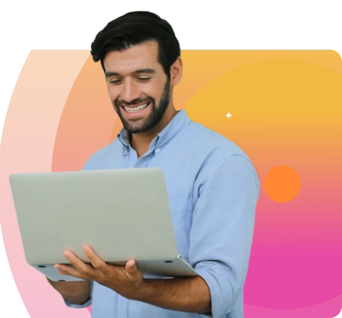 Smiling man holding a laptop